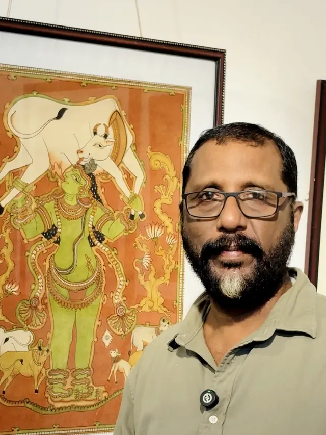 Dr. Saju Thuruthil beside his Kerala mural of Sree Krishna