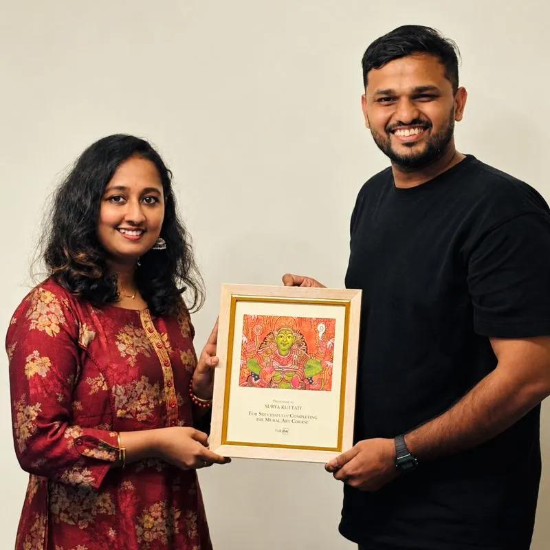 Surya Kottayi receiving her mural art course completion award