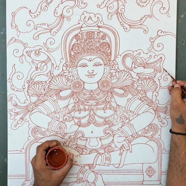 Outlining the Bhuvaneshwari drawing in red paint