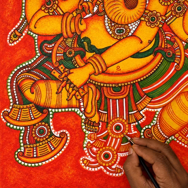 Painting the ornaments on the garments of the Ganesha mural with a fine brush