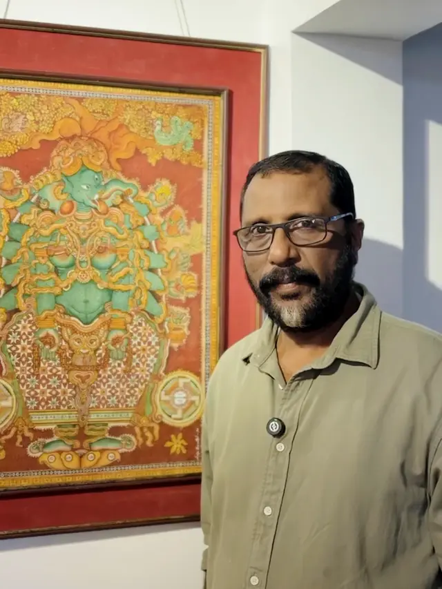 Dr. Saju Thuruthil beside his Kerala mural of Ganapathi