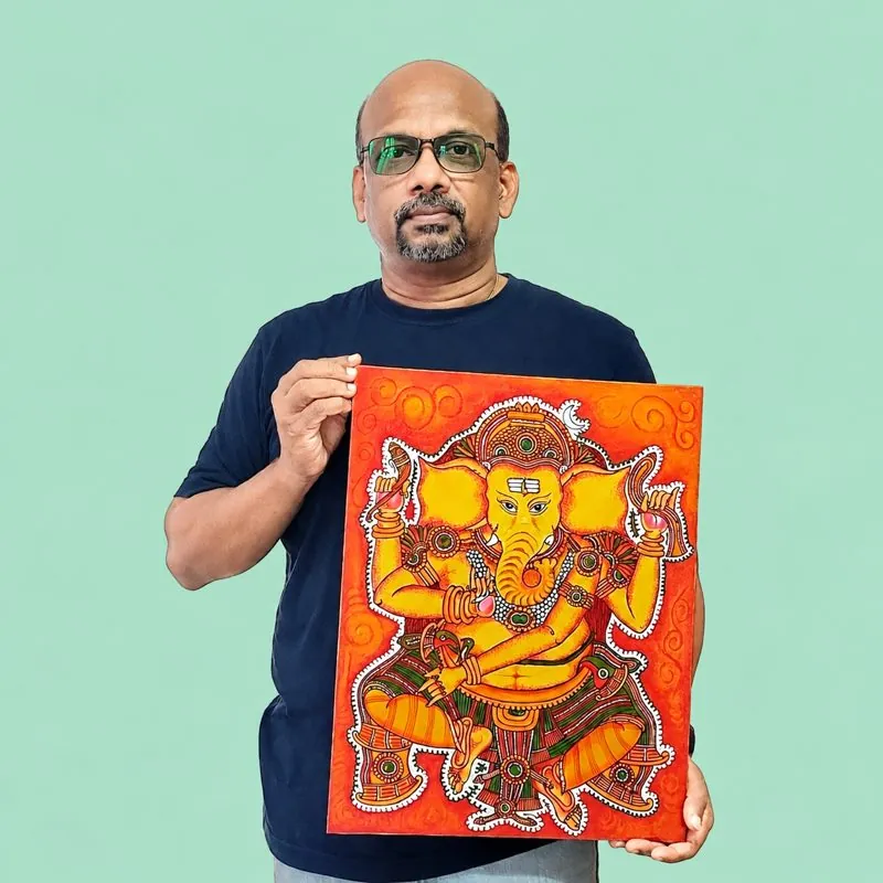 Dr. Baburaj holding his Kerala mural Ganapathi painting